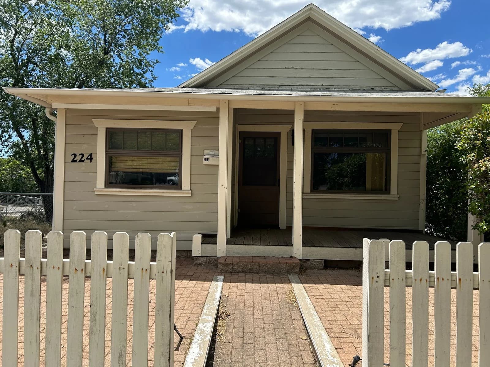 TDH residential property with a covered front porch and white picket fence